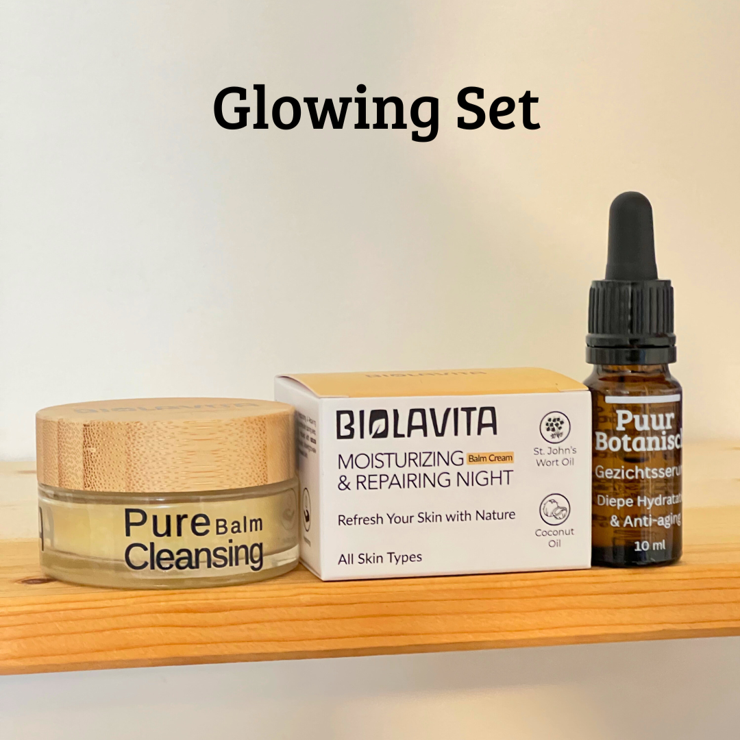Skincare products including a jar, box, and dropper bottle on a wooden surface with a blurred background.